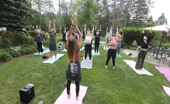 Guests in an outdoor group yoga class at a VWR retreat