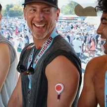A smiling guest wearing the Rythm device on his arm