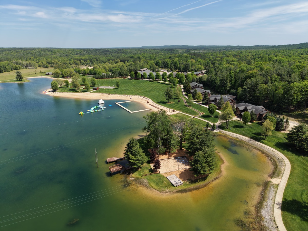 Aerial view of the Timber Wolf Lake campus, beach, and lodges