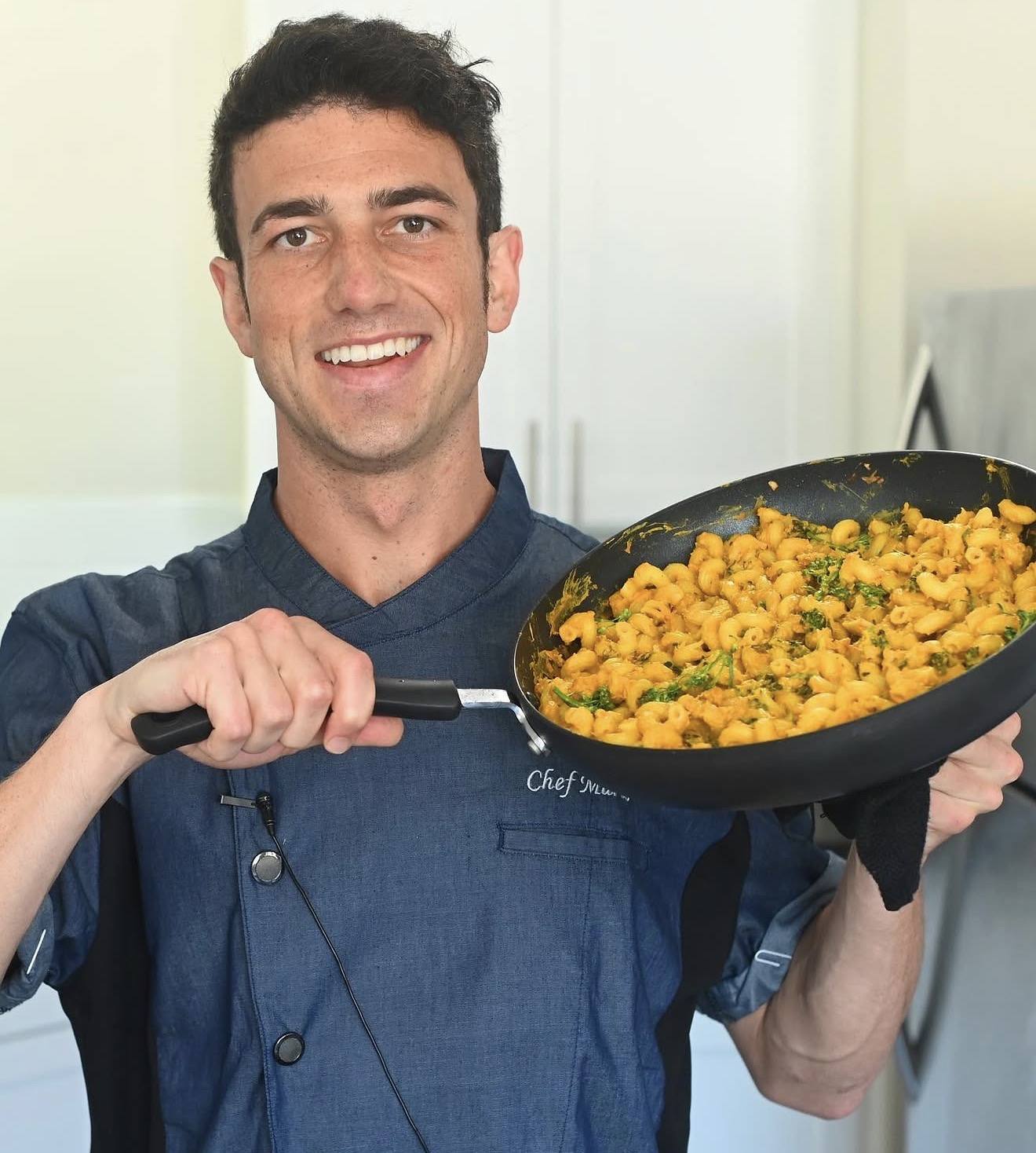 Head chef Mario Fabbri holding a pan of whole-food mac and cheese