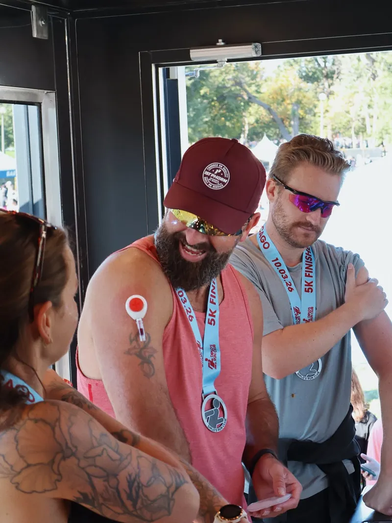 Two friends getting their bloodwork done at the Rythm Mobile Lab