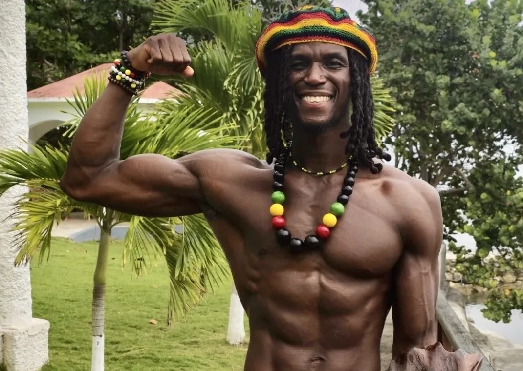 Scott Burnhard smiling and flexing his bicep