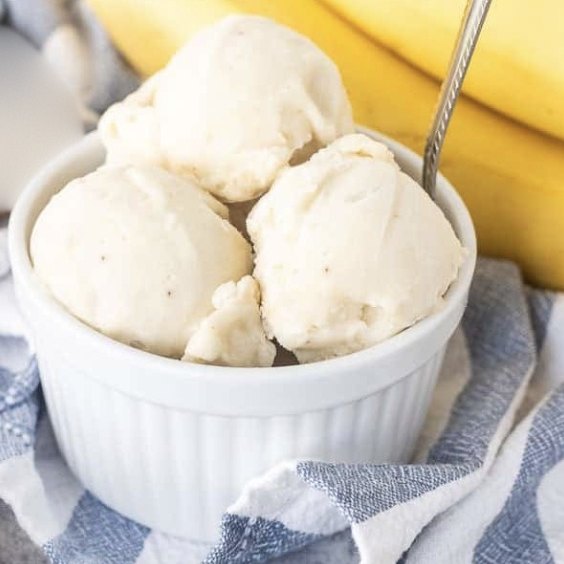 Three scoops of homemade banana ice cream in a white ramekin