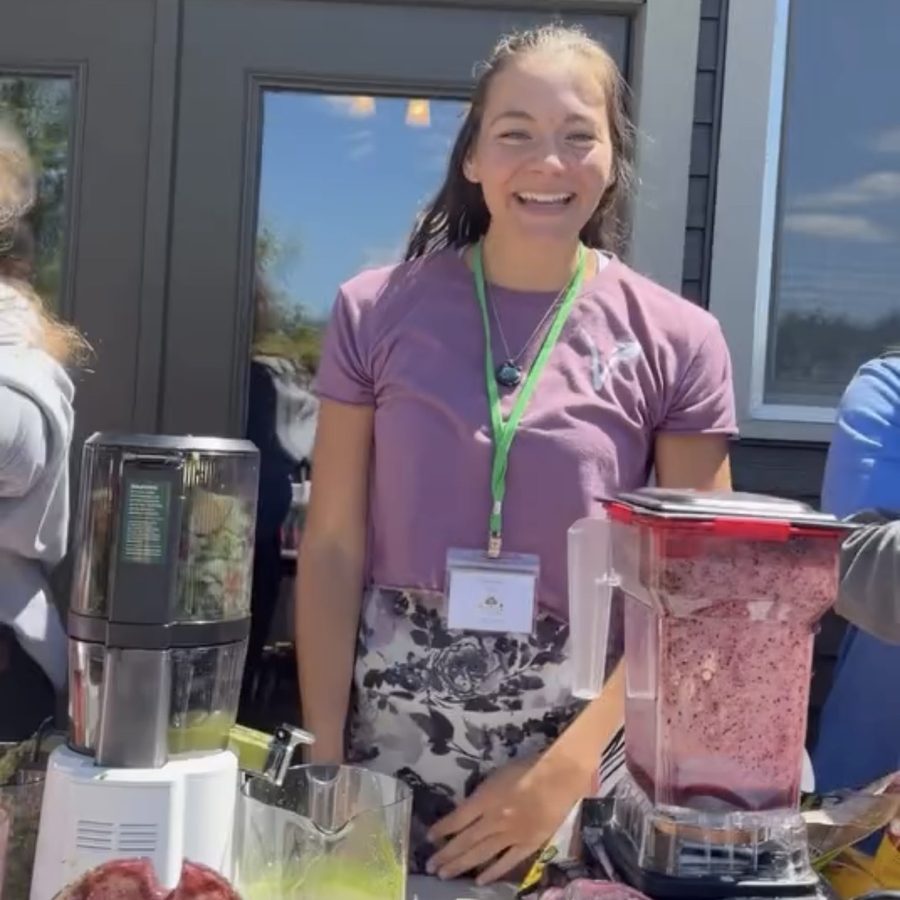 Behind the Triple Bar at the 2026 Michigan retreat: a juicer pressing green juice next to a blender full of berry smoothie